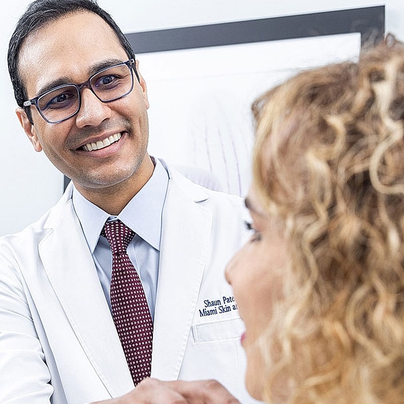 Doctor consulting with patient in medical setting.