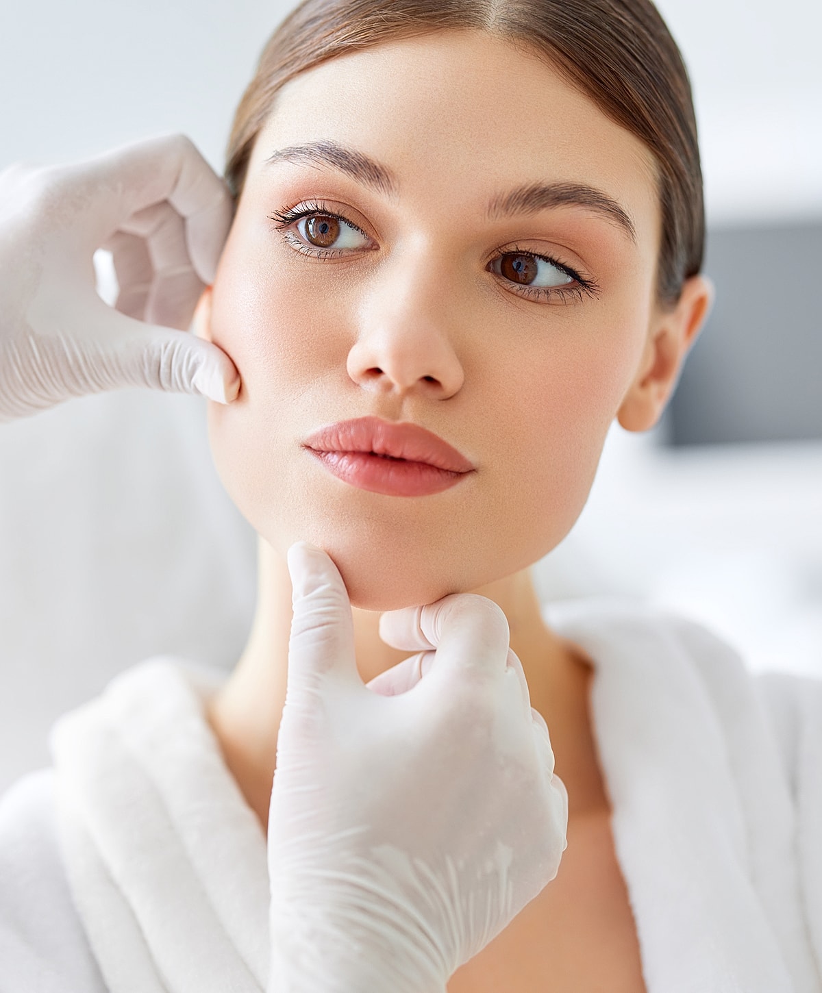 Doctor administering treatment to woman in clinic.