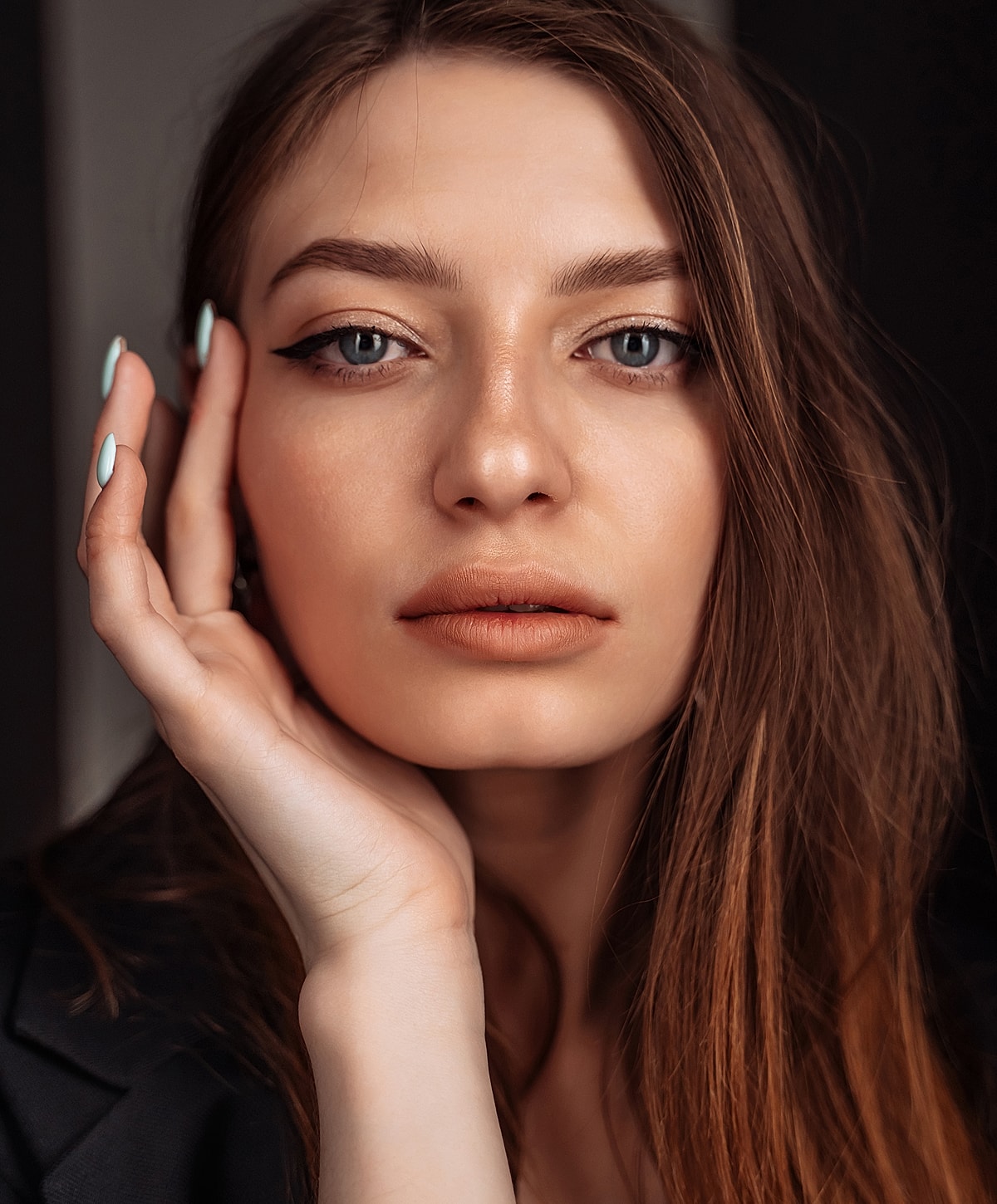 Woman with natural makeup and long hair.