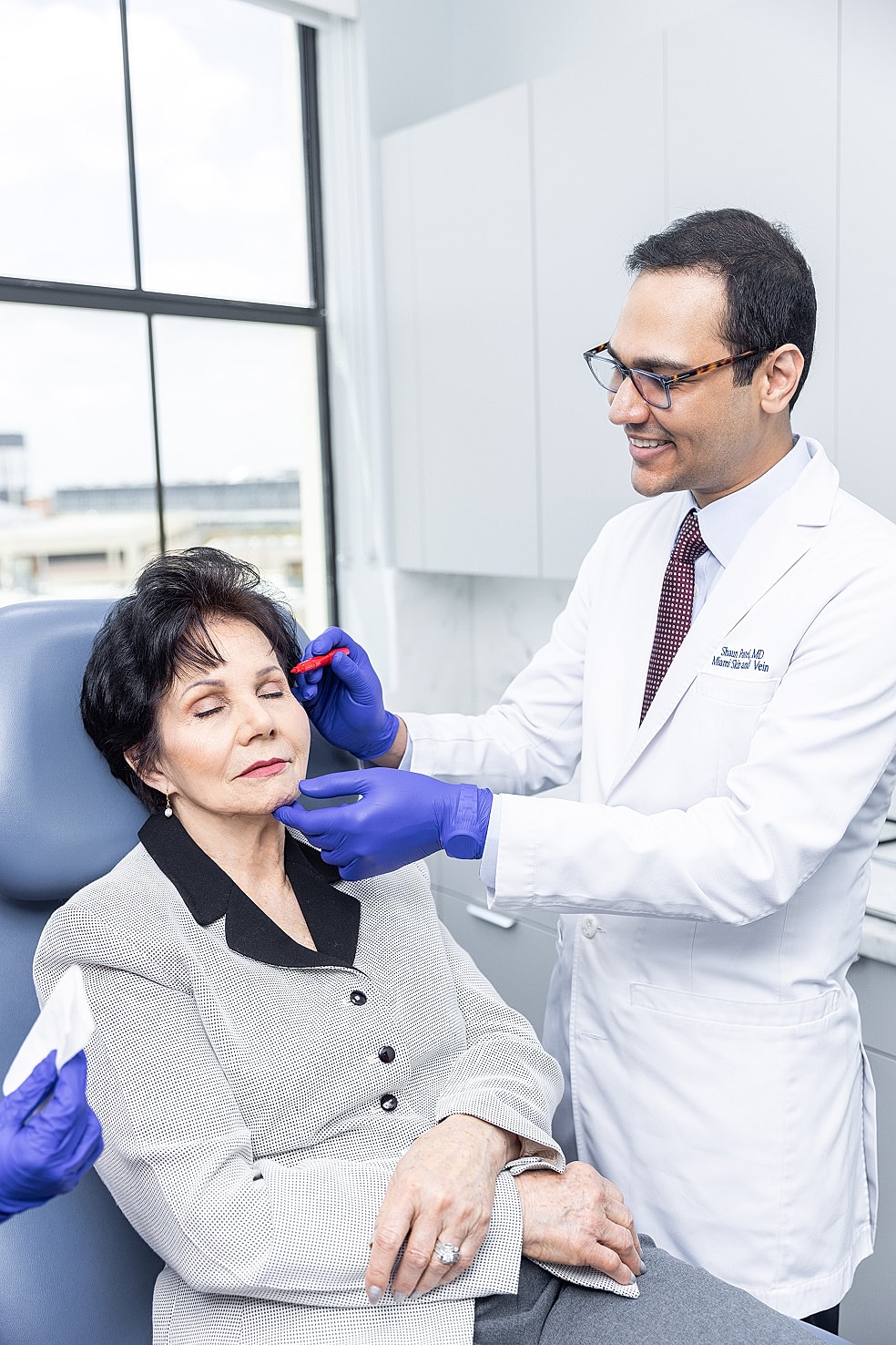 Doctor administering treatment to woman in clinic.
