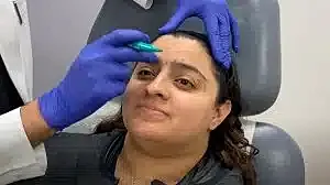 Patient receiving cosmetic treatment on her forehead.