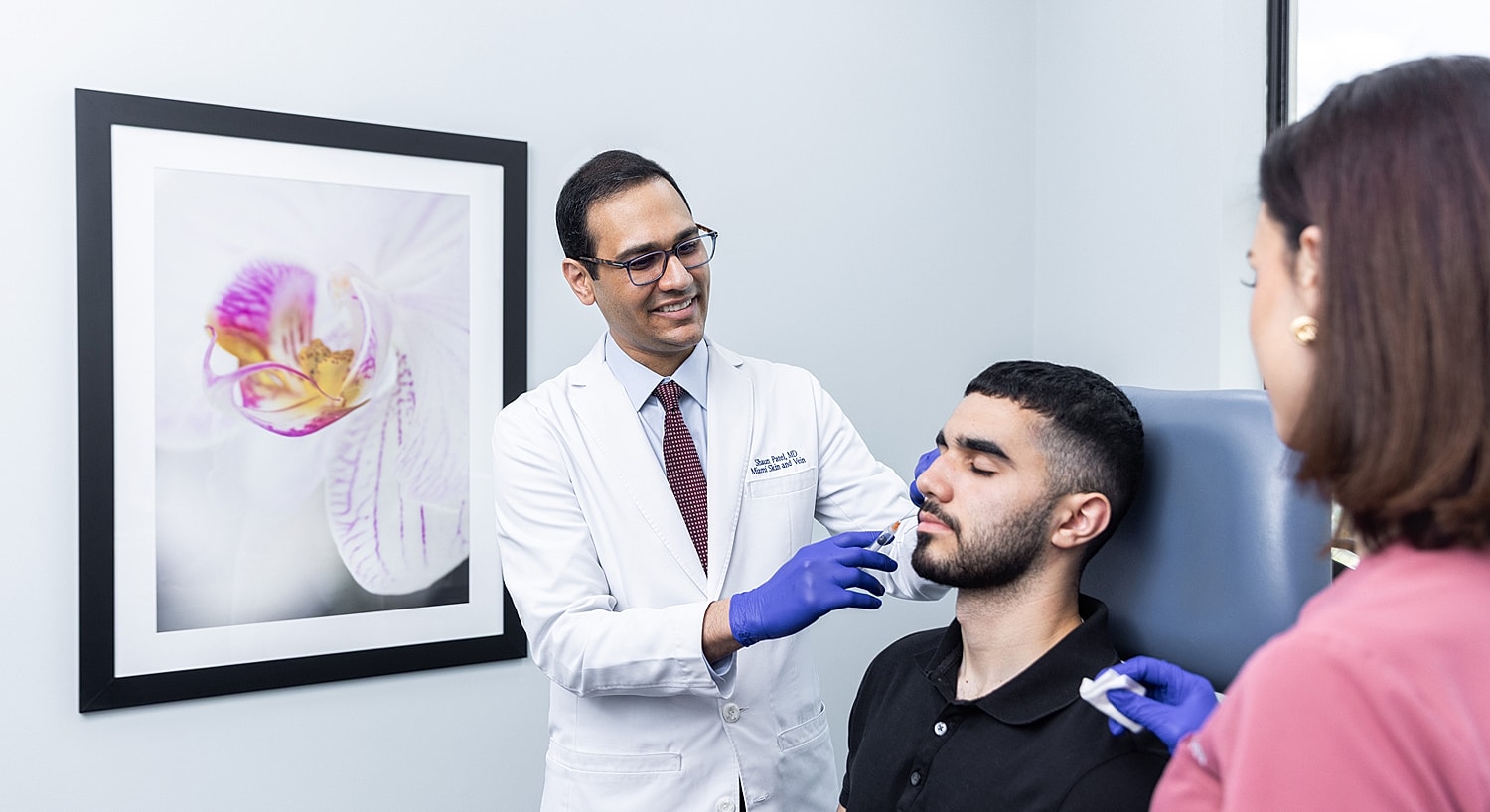 Doctor administering treatment in a medical office.