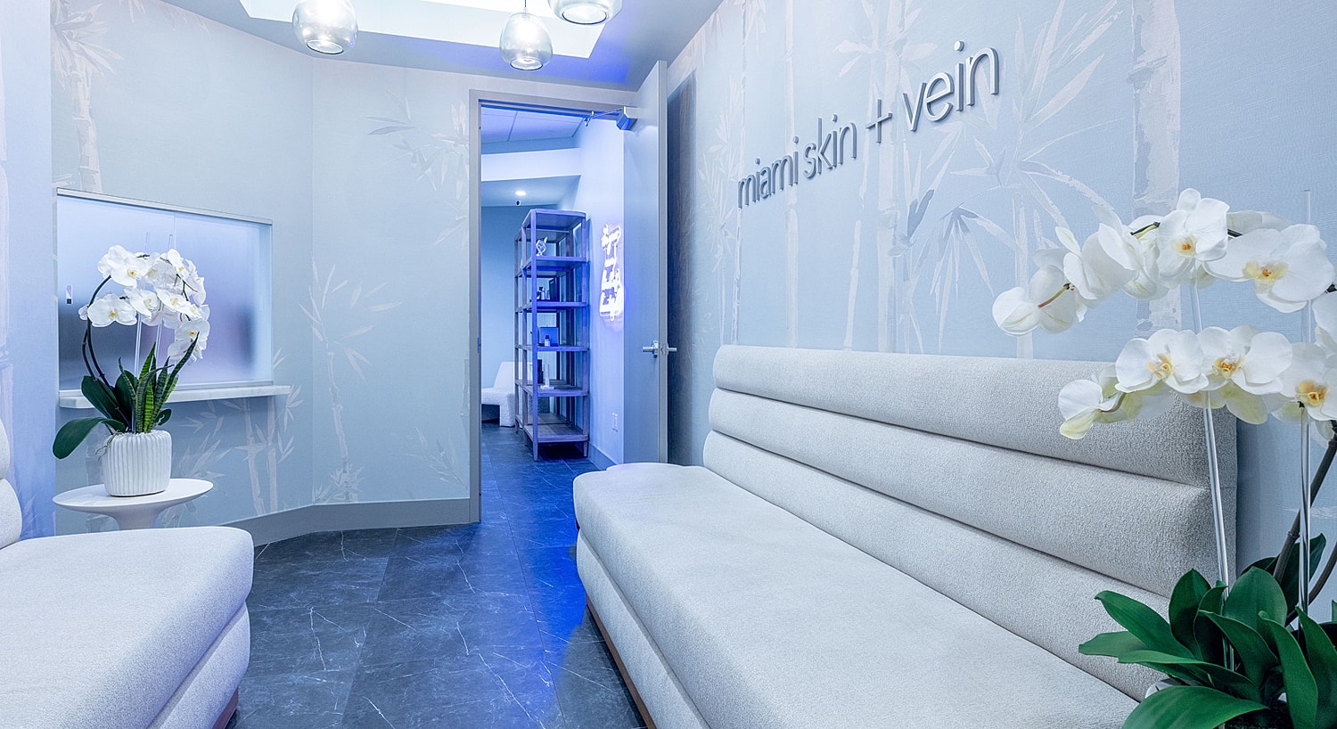 Modern clinic interior with seating and decor.