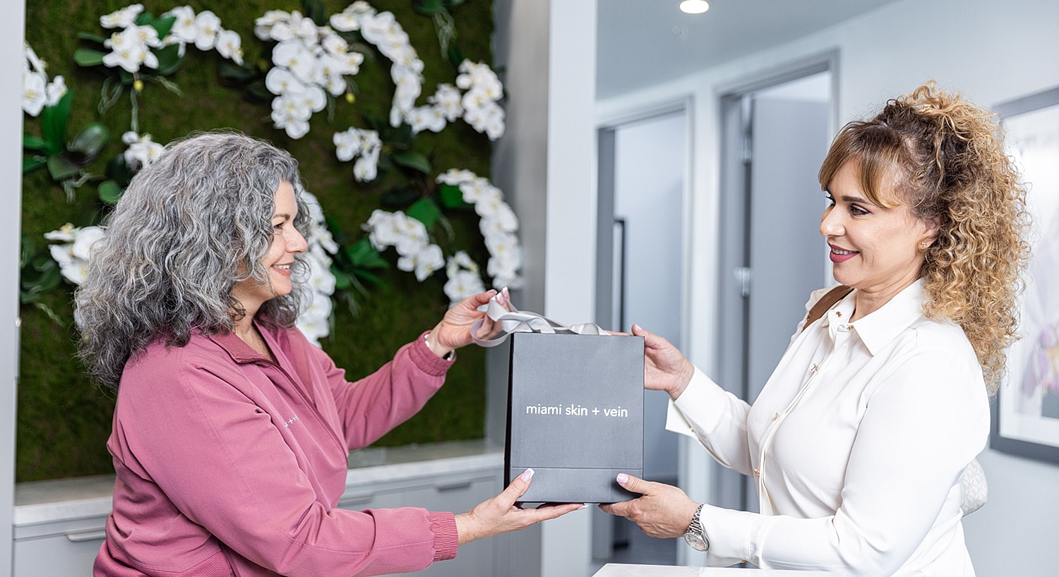 Customer receiving a gift at a skincare clinic.