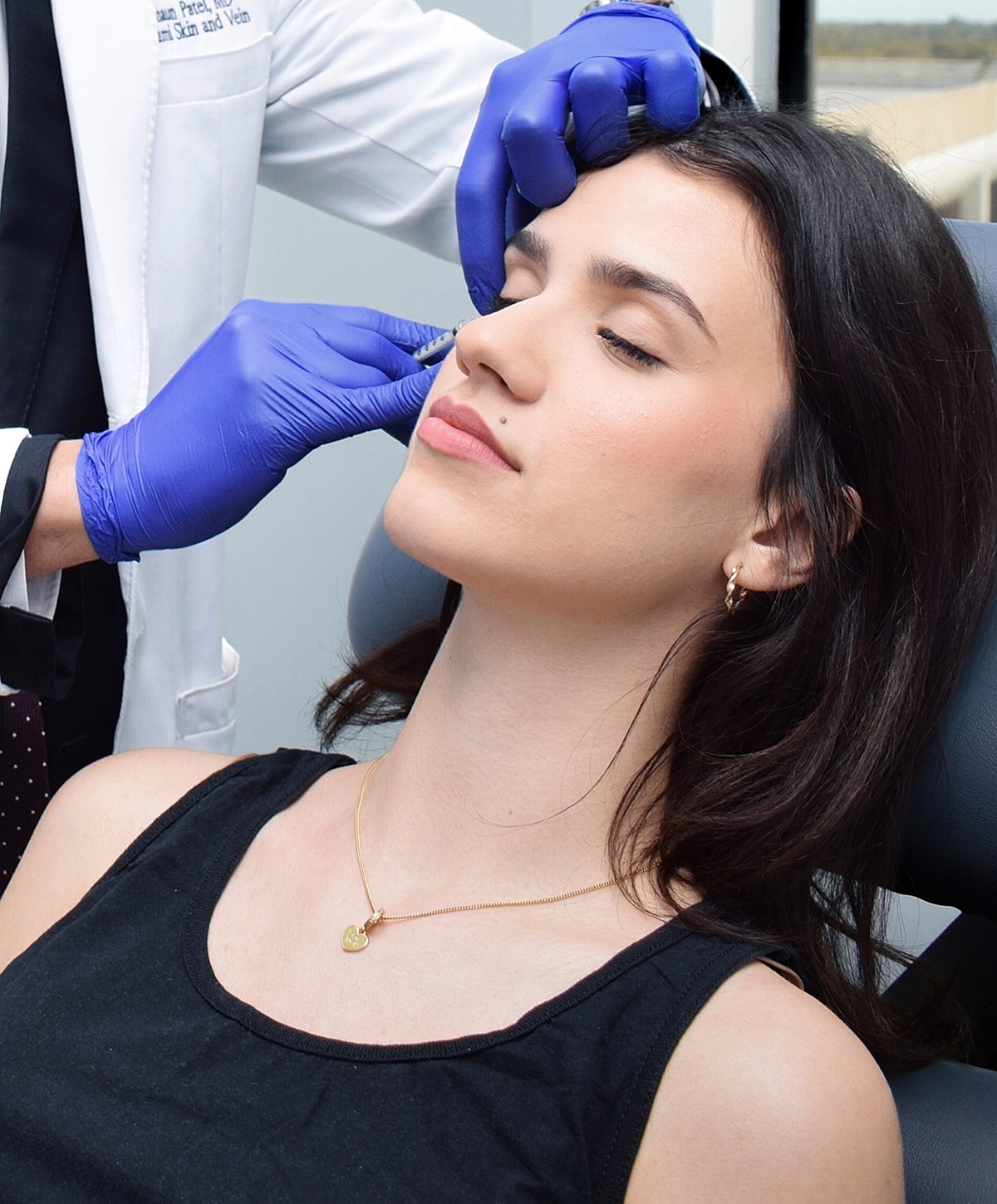 Doctor administering treatment to woman in clinic.