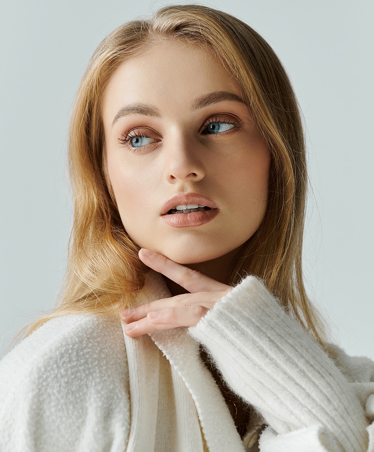 Woman with elegant hairstyle and white blouse.