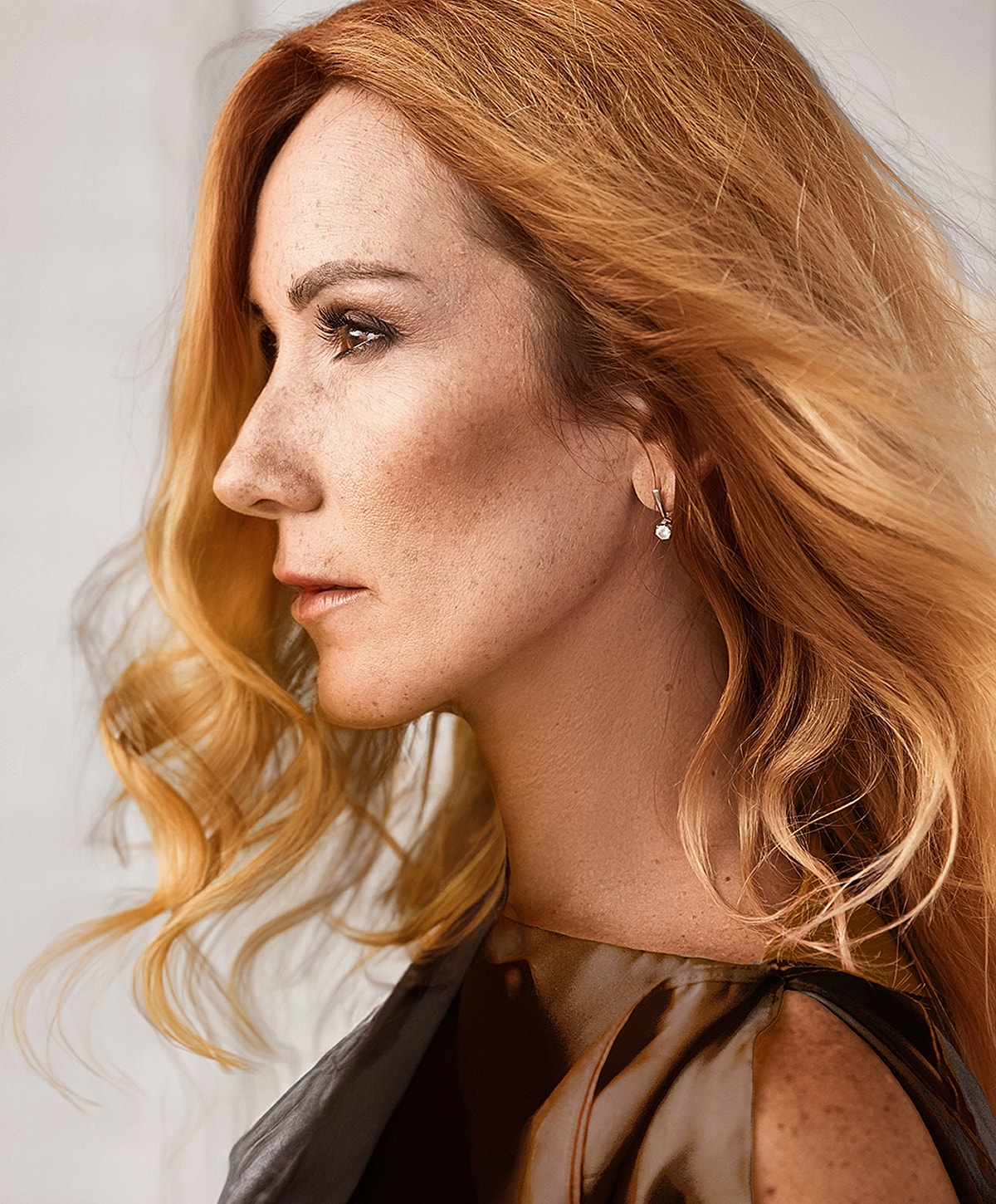 Profile of a woman with flowing, wavy hair.