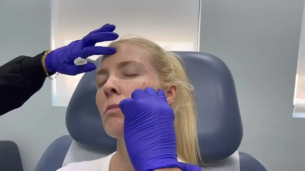 Facial treatment procedure happening in a clinic.