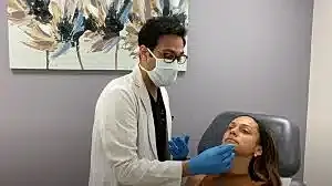 Doctor providing cosmetic treatment to a patient.