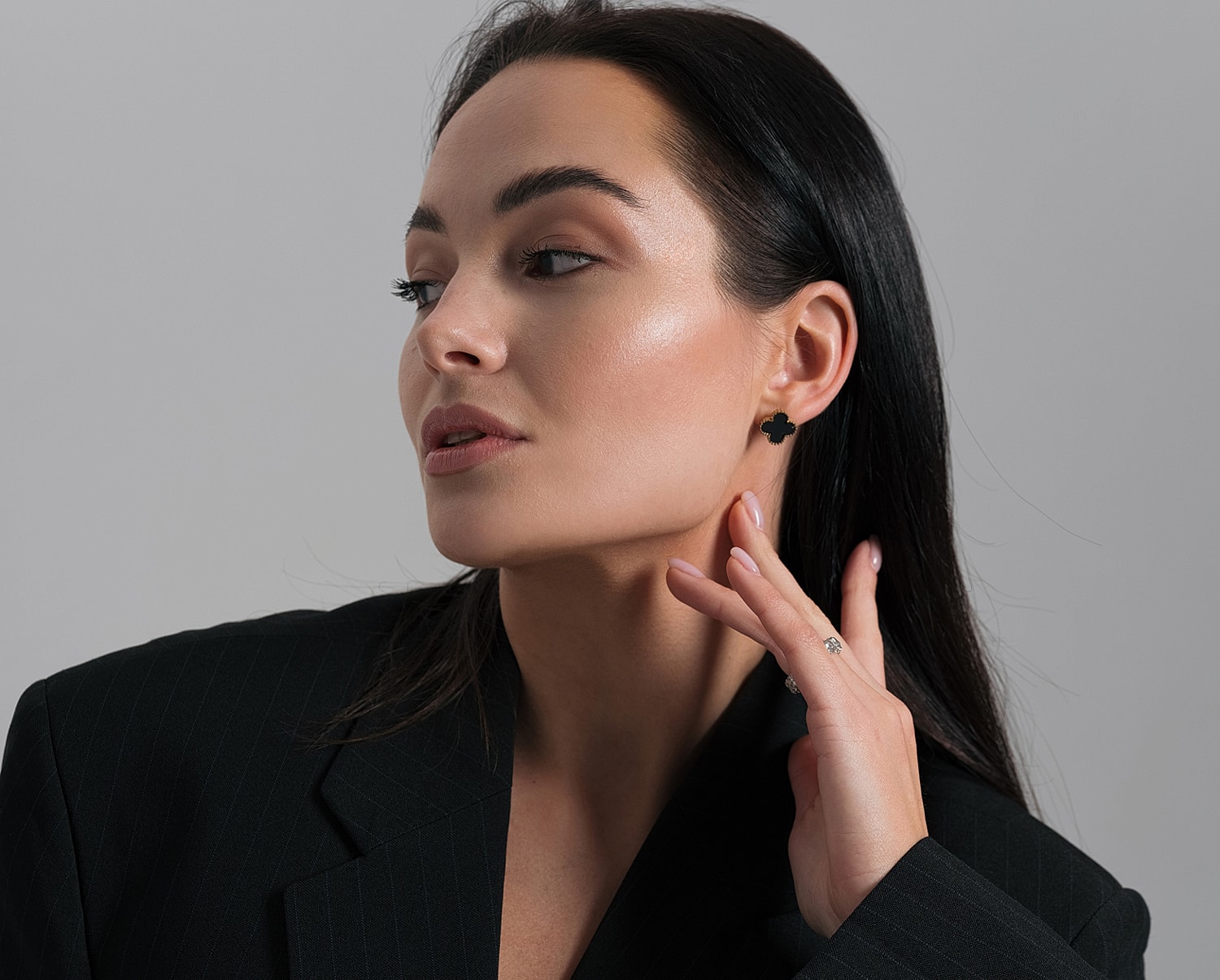 Model showcasing jewelry in elegant attire.