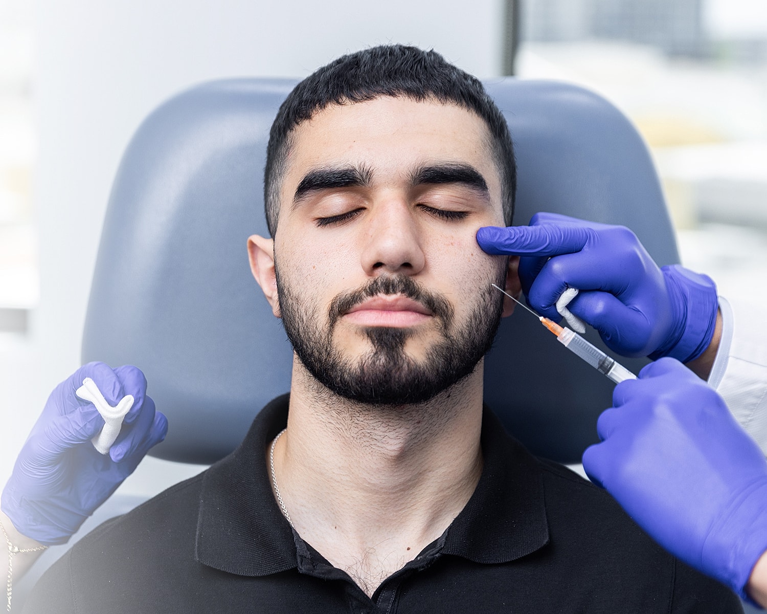 Man receiving cosmetic injection in a clinical setting.