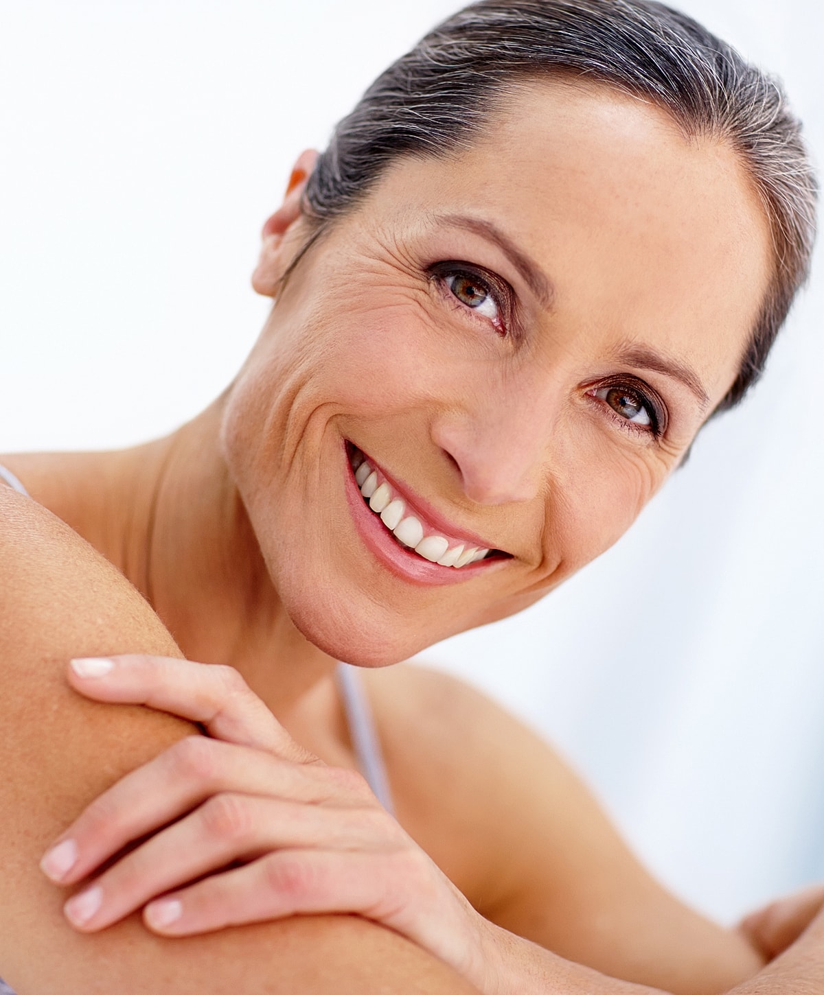 Smiling middle-aged woman with healthy skin.
