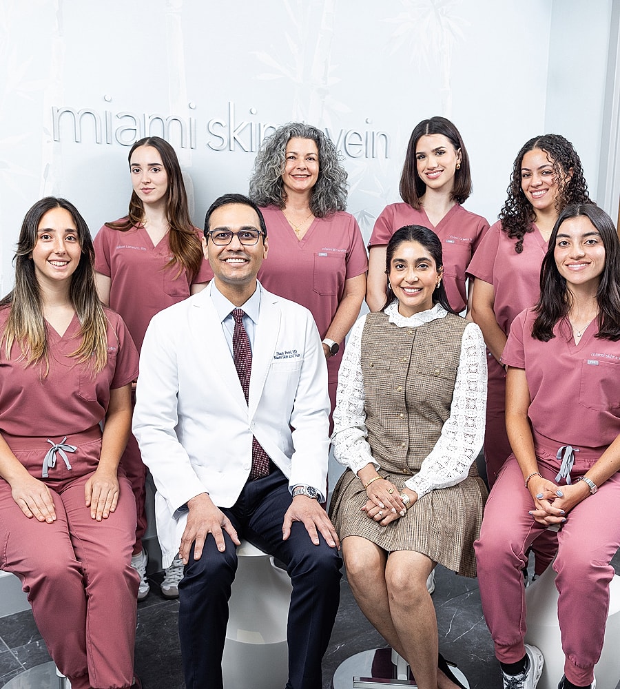 Medical team posing in a clinic setting.