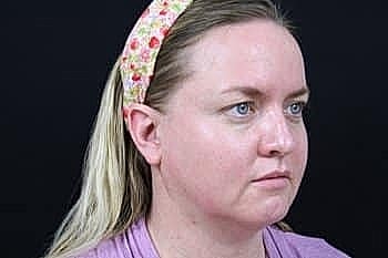 Woman with long hair and floral headband.