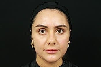 Woman with medium-length dark hair and minimal makeup.