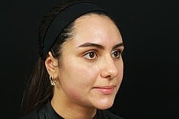 Woman with long hair and headband, side profile.