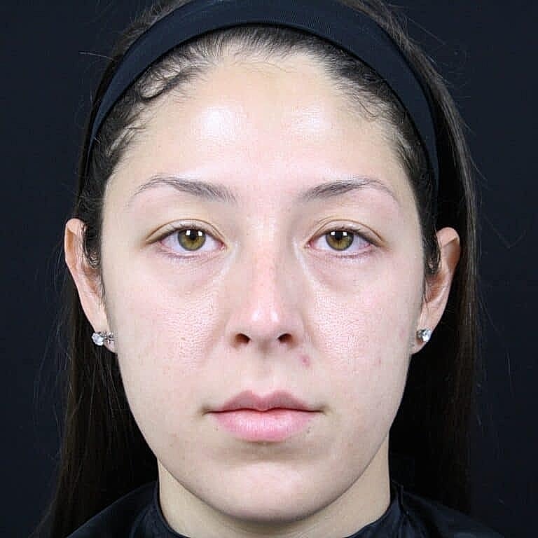 Portrait of a woman with neutral expression.