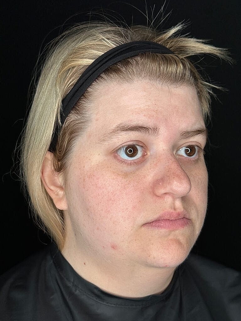 Woman with blonde hair and black headband.