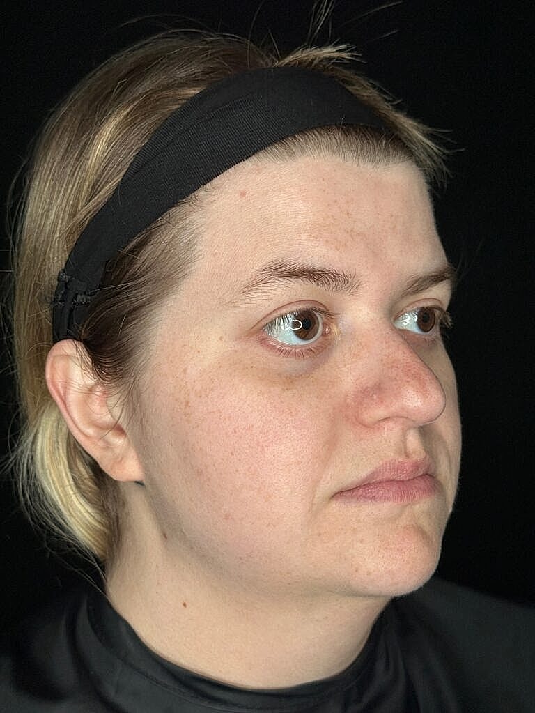 Profile of a woman with light makeup applied.