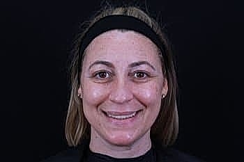 Smiling woman with light brown hair and headband.