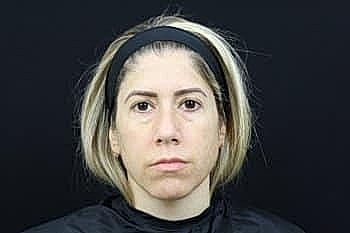 Woman with short blonde hair in portrait.
