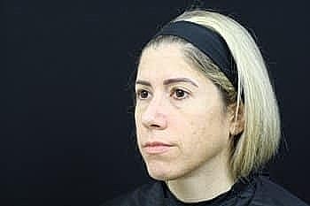 Woman with short blonde hair and headband.