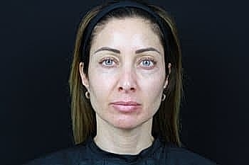 Woman with natural makeup on a dark background