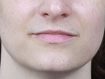 Close-up of a person's lips and chin.