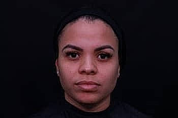 Portrait of a woman with dark background.