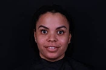 Portrait of a woman against a dark background.