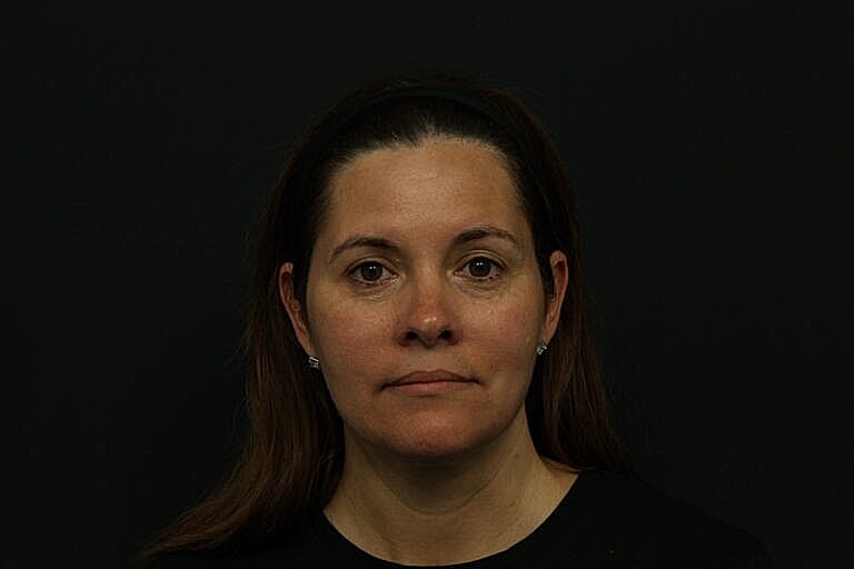 Portrait of a woman against a dark background