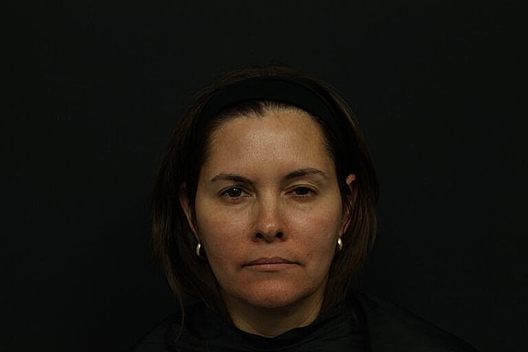 Portrait of a woman against a dark background.