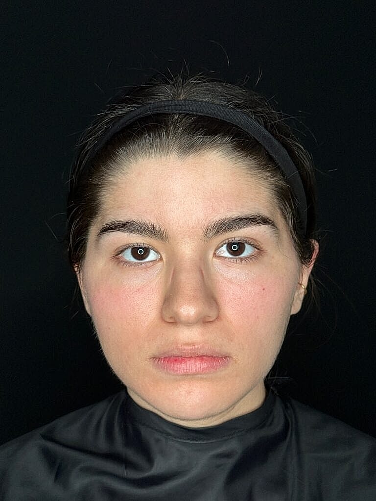 Portrait of a woman with neutral expression.