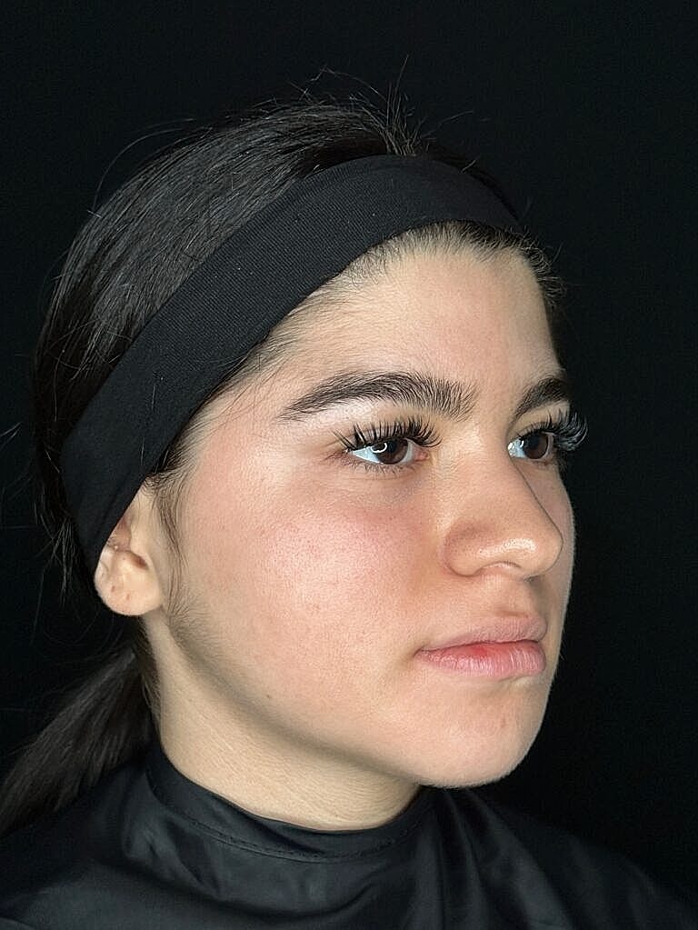 Profile of a young woman with makeup.