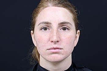 Portrait of a woman with a serious expression.