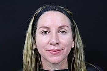 Woman with long hair and neutral expression