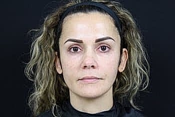 Woman with natural makeup against black background