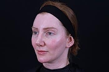 Woman with headband against dark background
