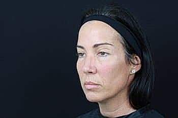Woman with serious expression against black background