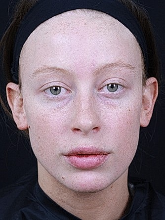 Model with natural makeup and freckled skin.