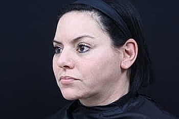 Woman with dark hair in profile view.