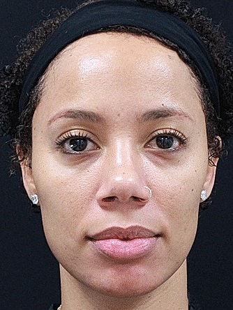 Portrait of a woman with short curly hair.