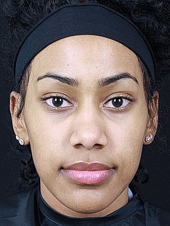 Young woman with natural makeup and headband.