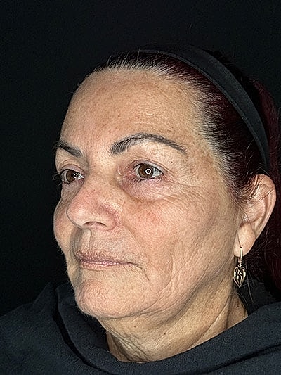 Profile of a woman with jewelry and natural expression.