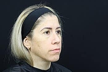Woman with blonde hair in profile view.