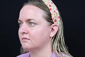 Portrait of a woman with a floral headband.