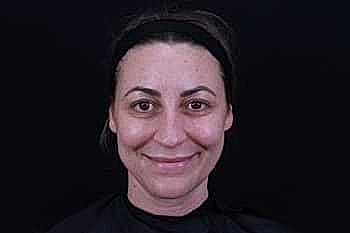 Smiling woman with dark hair and headband.