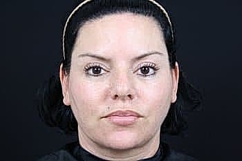 Woman with dark hair and natural makeup.