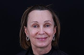 Smiling woman with short hair and earrings