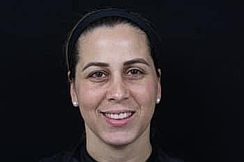 Smiling woman with dark hair and headband.